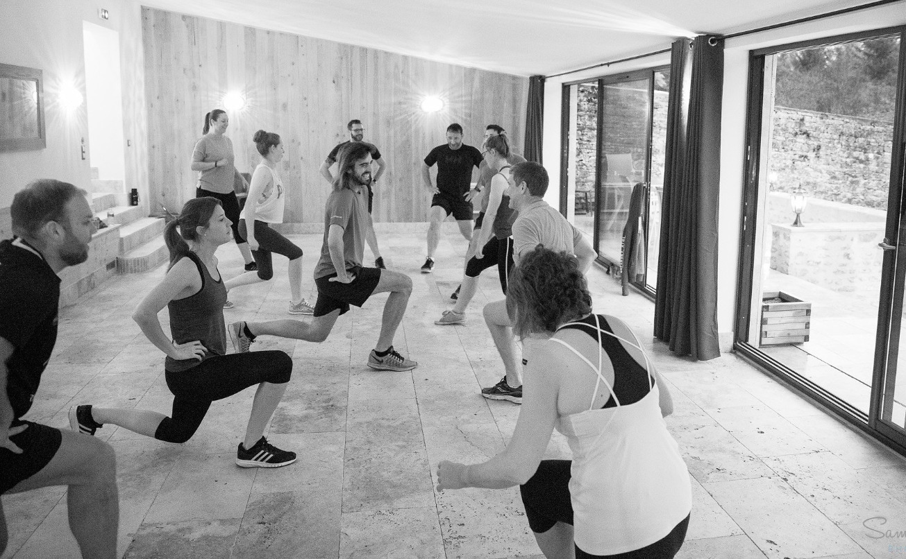 Group fitness training session with participants doing lunges